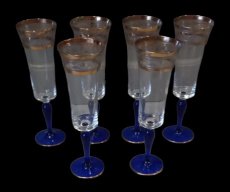 6 cobalt and gold champagne glasses.